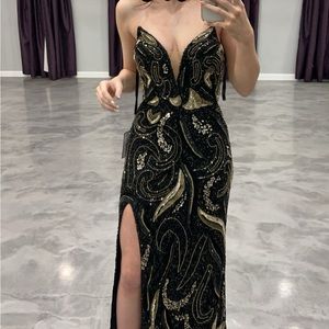 This is a black and gold strapless prom dress. Size 00. Fits true to size.